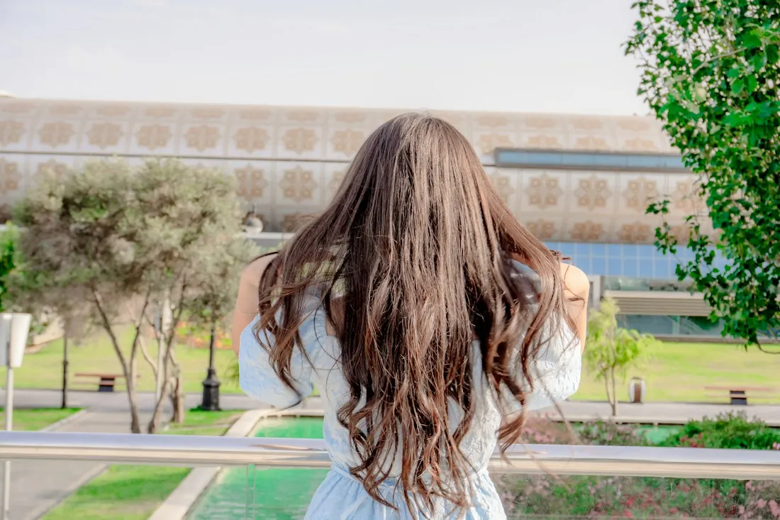 Long, full wavy brown hair seen from behind